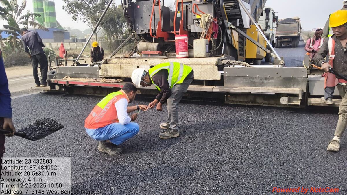 Site engineers checking mix temperature and texture at the paver screed