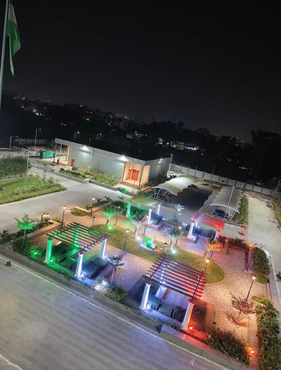 Paved plaza, planting, lighting and tensile-roof parking built as external works at the control centre complex