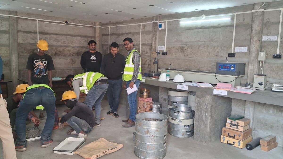 Site laboratory with engineers and technicians running material tests